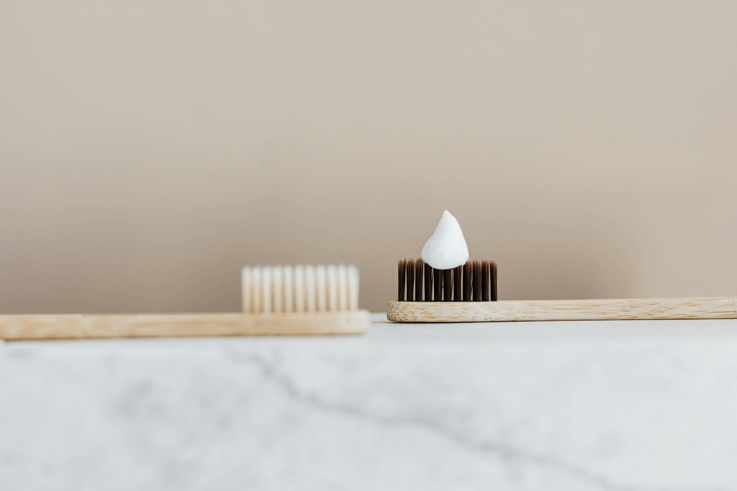 Two bamboo toothbrushes, one with toothpaste - Periodontist Southern Pines & Sanford NC | Van Scoyoc Periodontics & Implants Two bamboo toothbrushes, one with toothpaste
