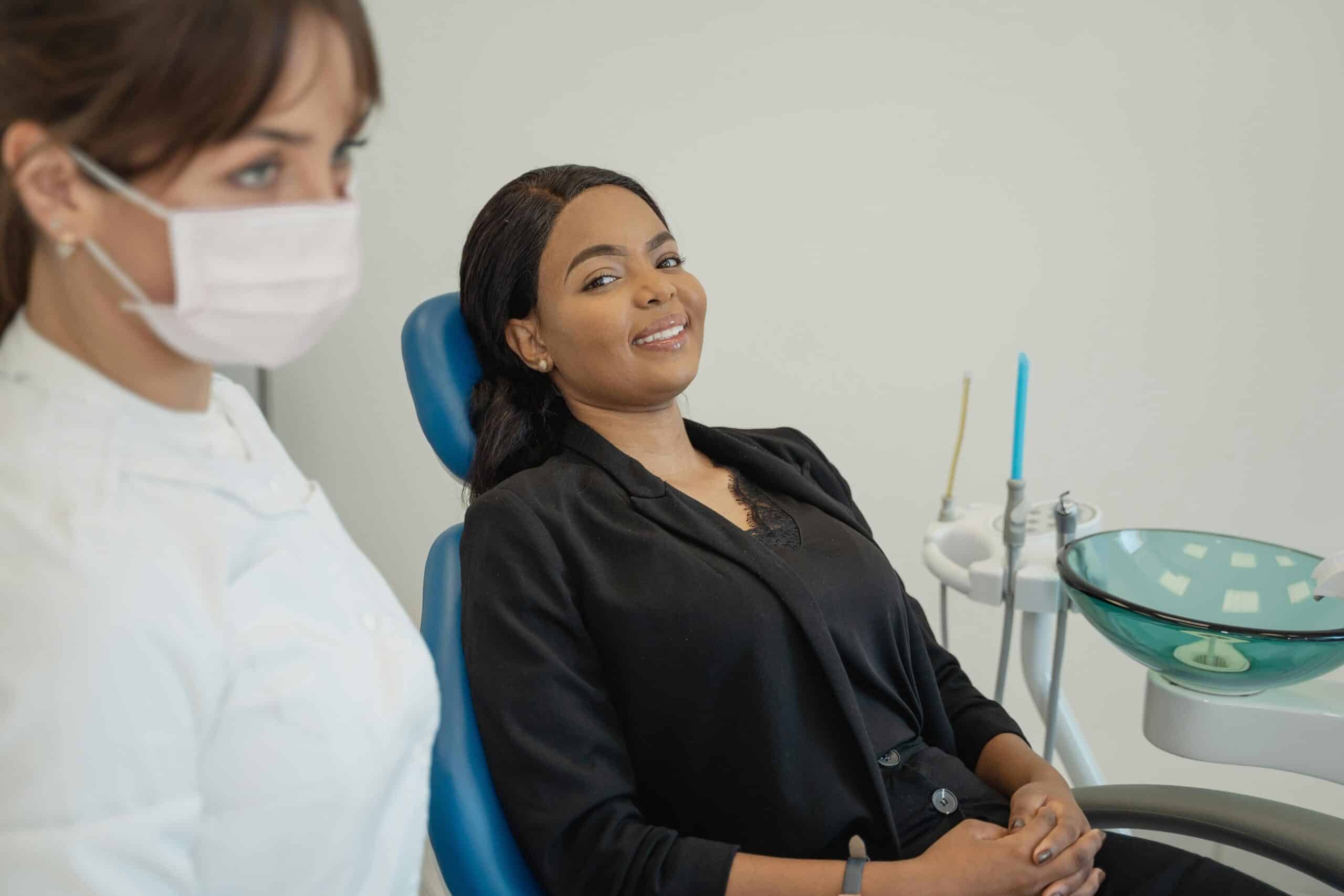 Patient smiling in the dental chair next to a dental assistant - Periodontist Southern Pines & Sanford NC | Van Scoyoc Periodontics & Implants Patient smiling in the dental chair next to a dental assistant