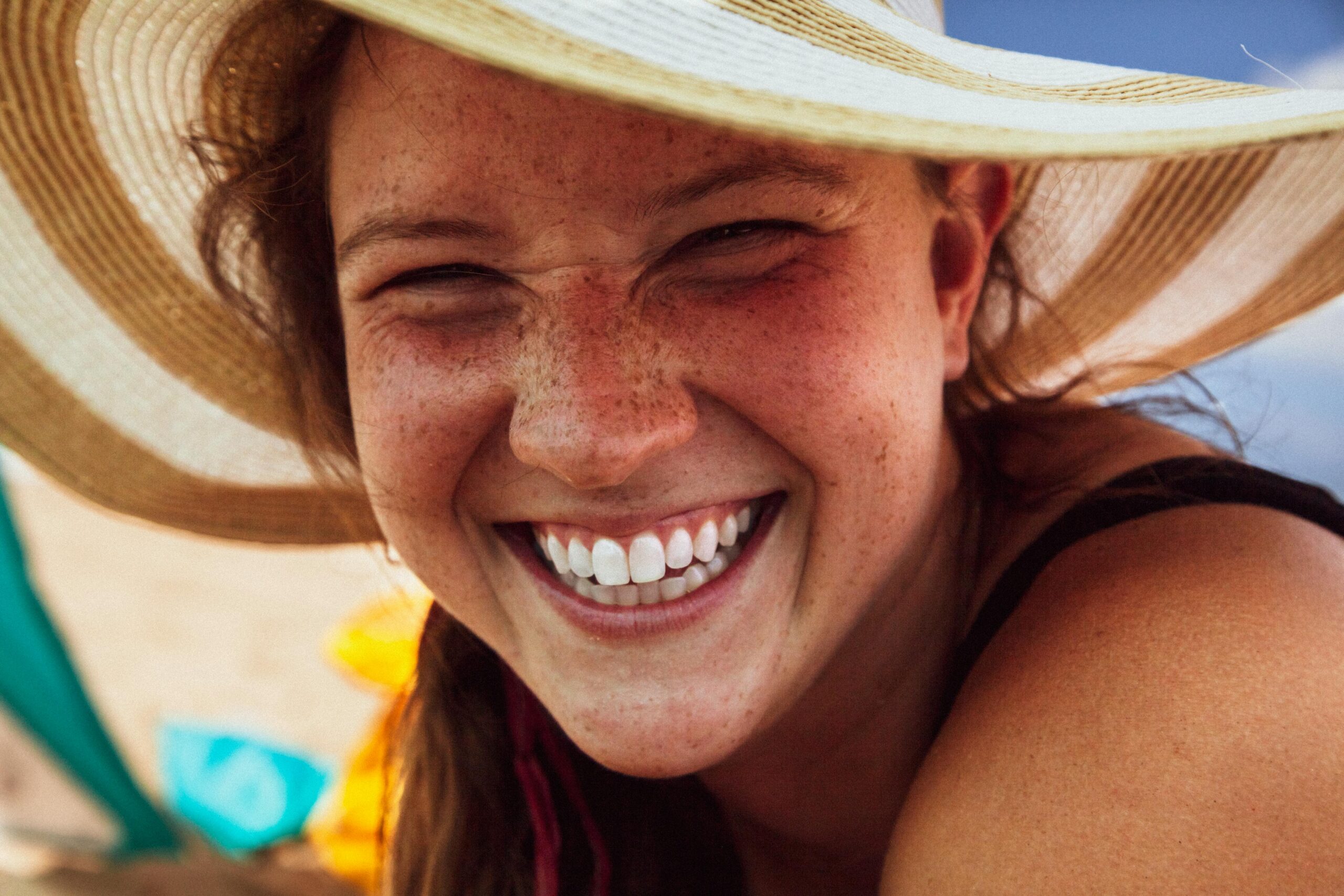 Woman in a sun hat with a big smile - Periodontist Southern Pines & Sanford NC | Van Scoyoc Periodontics & Implants Woman in a sun hat with a big smile